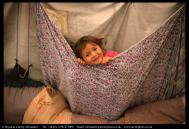 Mani, a young Innu girl plays in a tent at her family&rsquo;s autumn hunting camp in Labrador, Canada. Bryan and Cherry Alexander Photography.